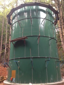 A tall green storage tank