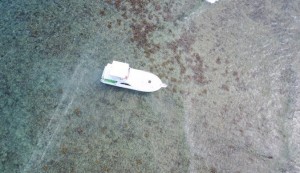 The grounded boat crashed into shallow corals on February 18. The dark patches around the boat are threatened elkhorn corals.