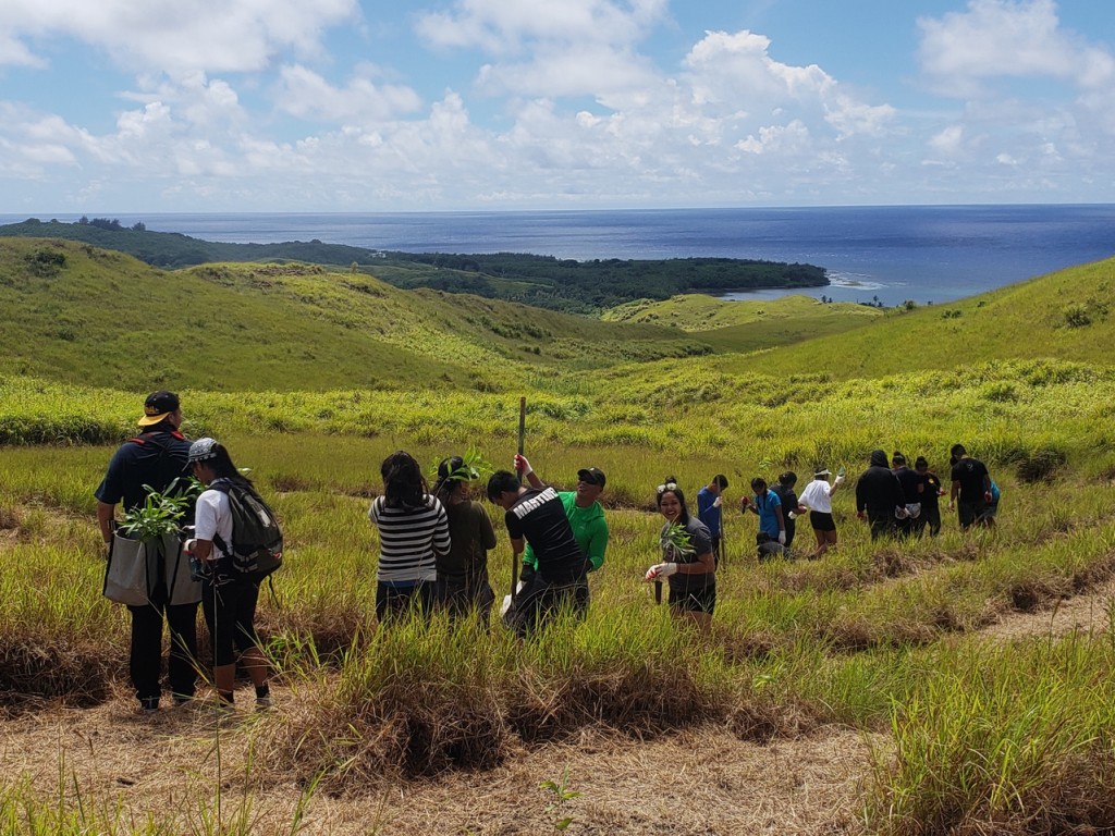 Community members in Manell-Geus Habitat Focus Area forest restoration efforts. Photo: Guam BSP/Patrick Keeler. 